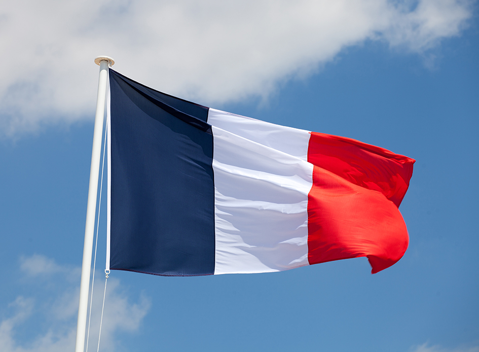 French flag against blue cloudy sky