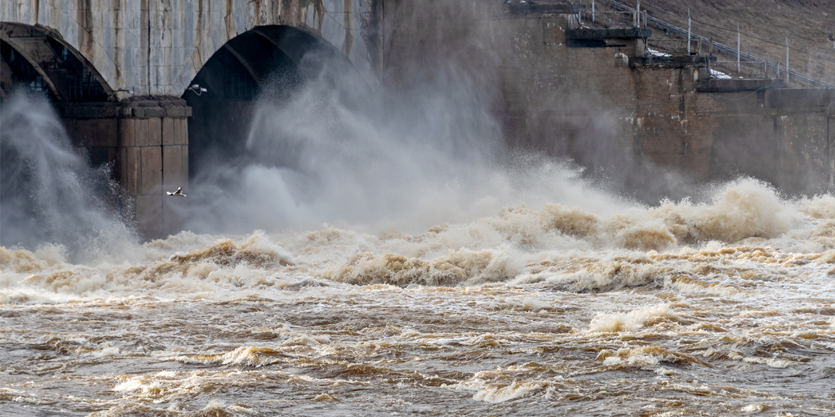 Discharge of water from the dam on the river during the spring flood.