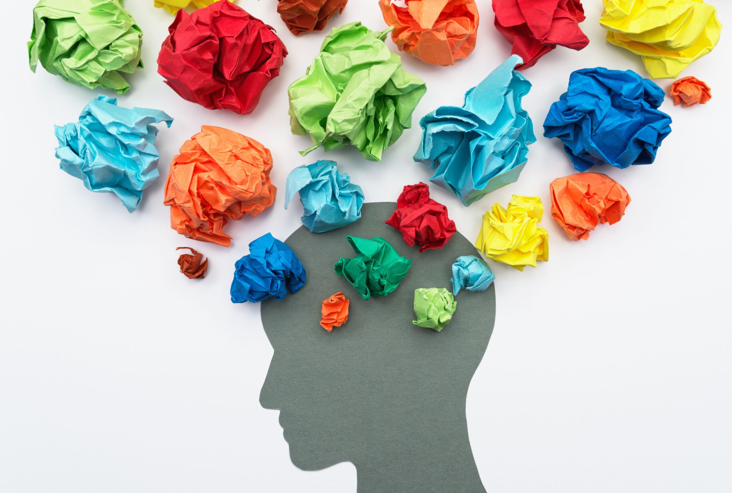 A head with colorful paper around it.