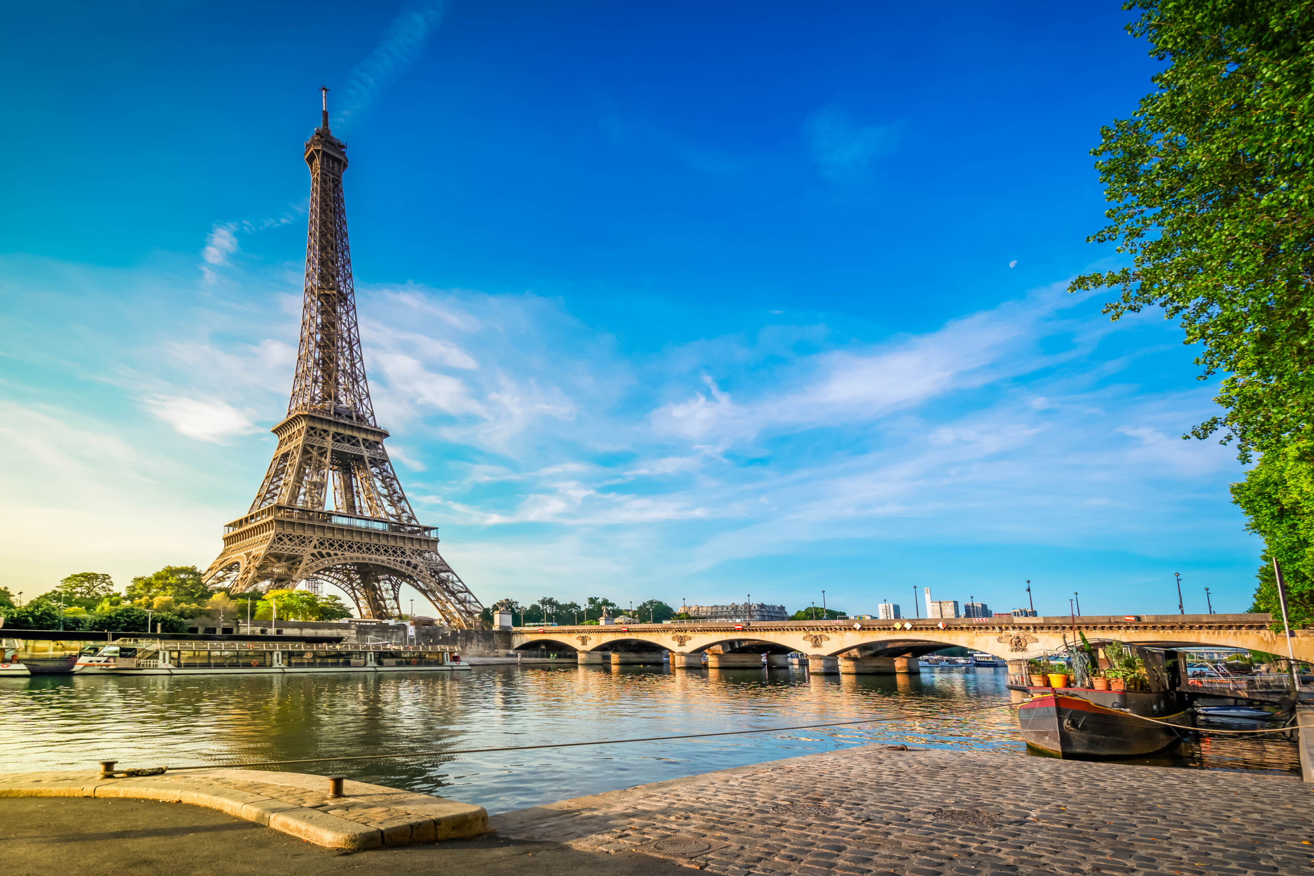 Paris Eiffel Tower reflecting in river Seine with bridge Pont dIena in Paris, France.